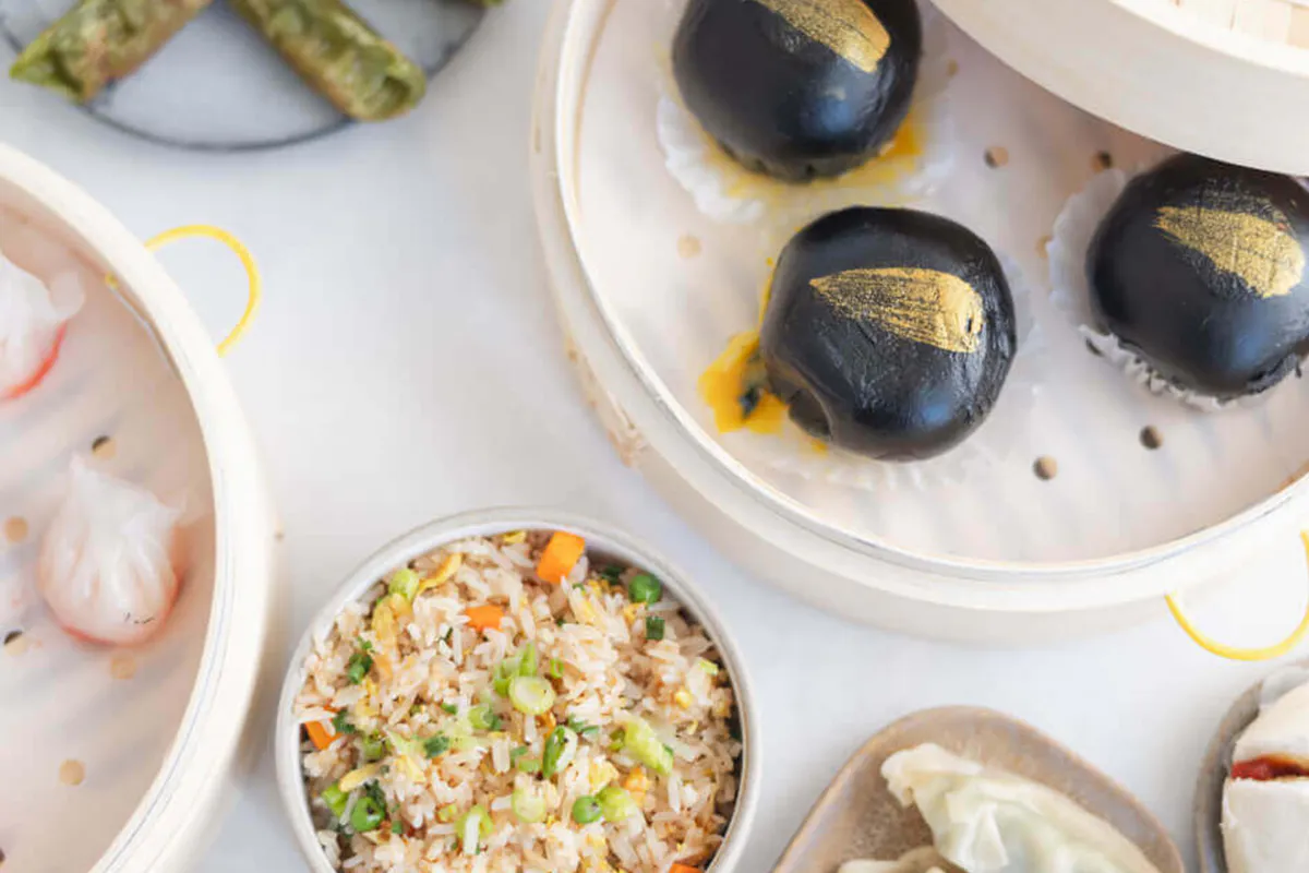 Assorted dim sum platter with black lava buns, har gow and vegetable fried rice at One More Bite Dumpling, a Chinese Restaurant in Yucaipa