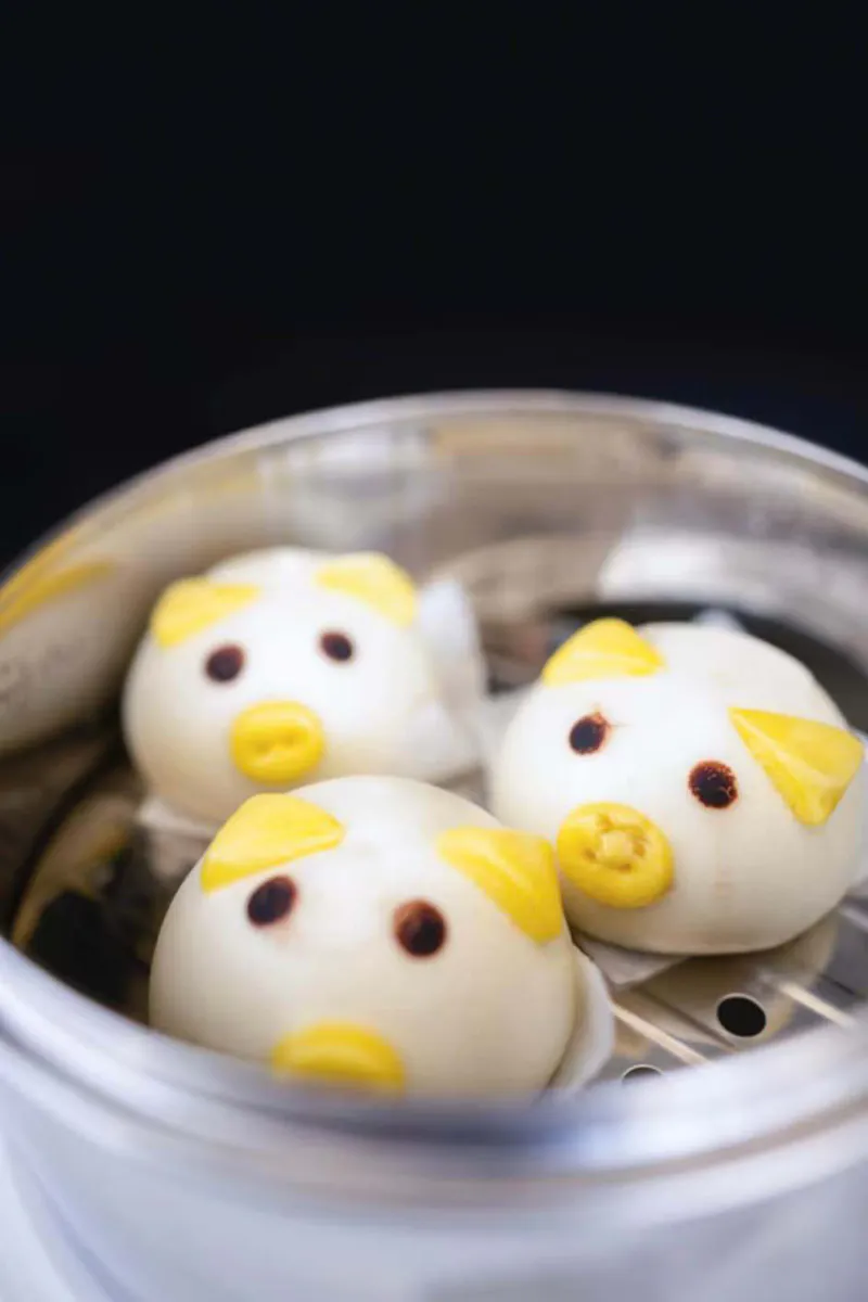 Cute pig shaped steamed buns inside metal steaming pot at One More Bite Dumpling, a Chinese Restaurant in Yucaipa