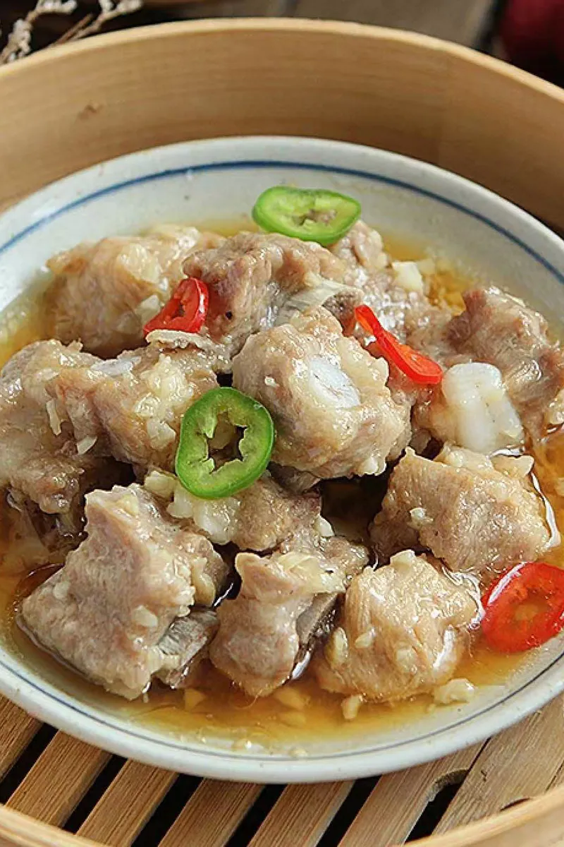 Steamed garlic spare ribs garnished with sliced green and red chili peppers at One More Bite Dumpling, a Chinese Restaurant in Yucaipa