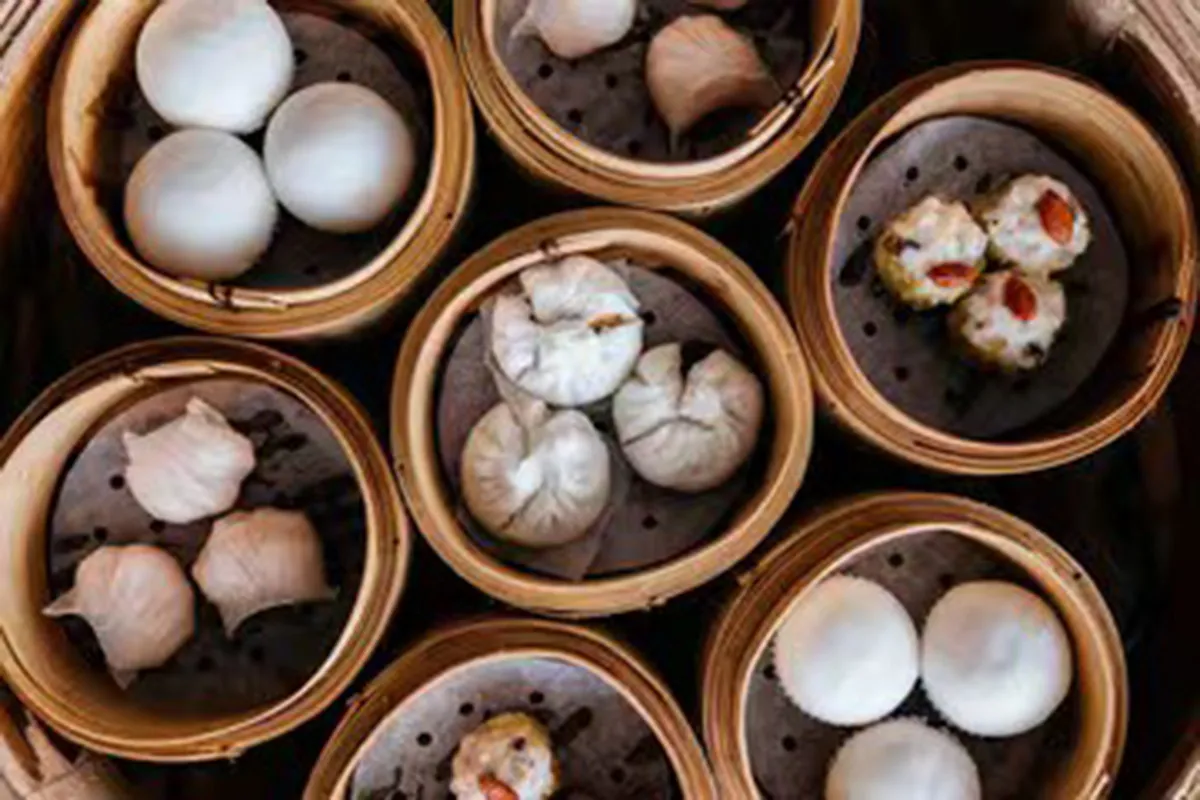Top-down view of assorted dim sum varieties served in multiple bamboo steamers at One More Bite Dumpling, a Chinese Restaurant in Yucaipa
